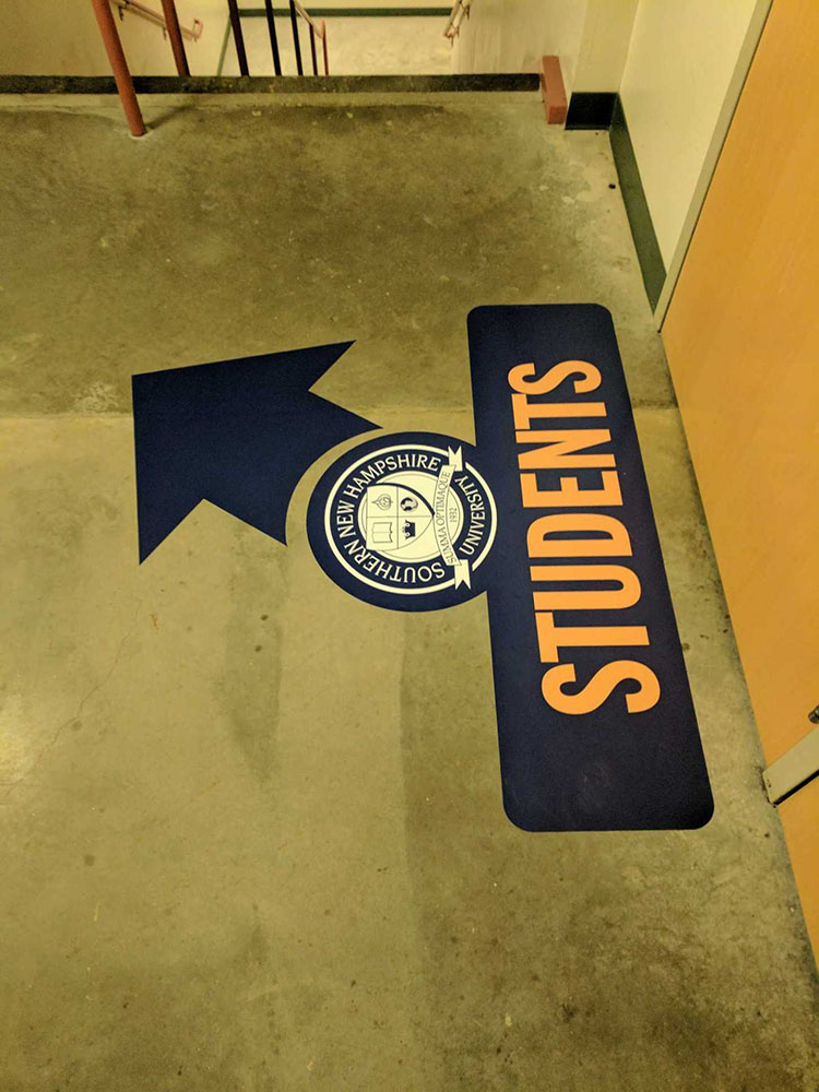 Floor graphics used for wayfinding signage at Southern New Hampshire University 
