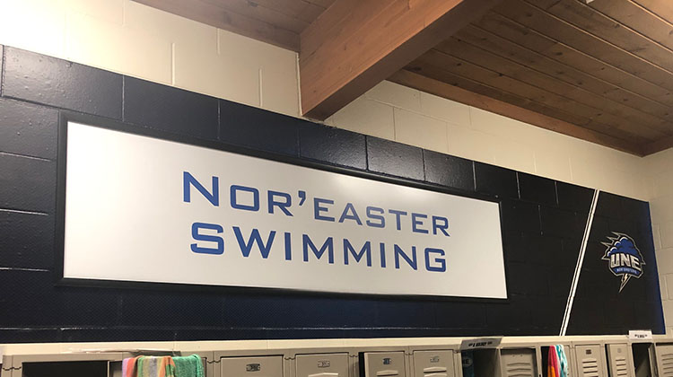University of New England Swimming locker room signage